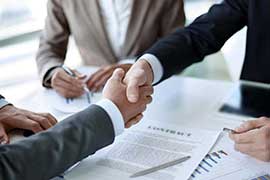 Two business men shaking hands during a meeting to sign agreement and become a business partner, enterprises, companies, confident, success dealing, contract between their firms